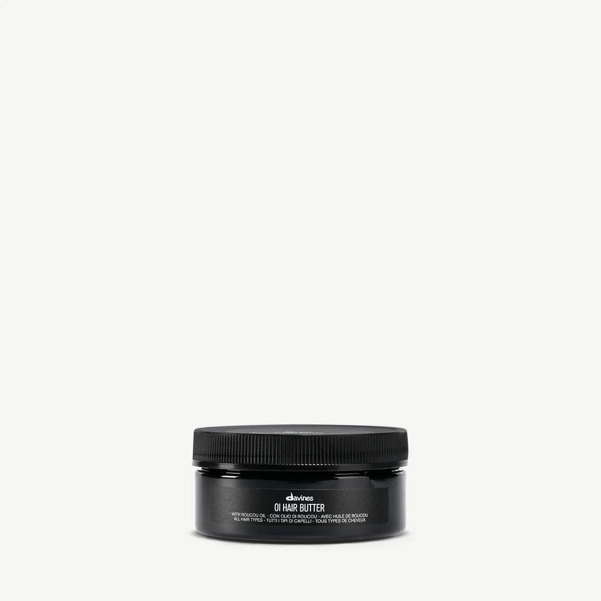 Svart burk med Davines OI/Hair Butter, en miljövänlig hårprodukt för styling och vård som ger näring och glans till håret.