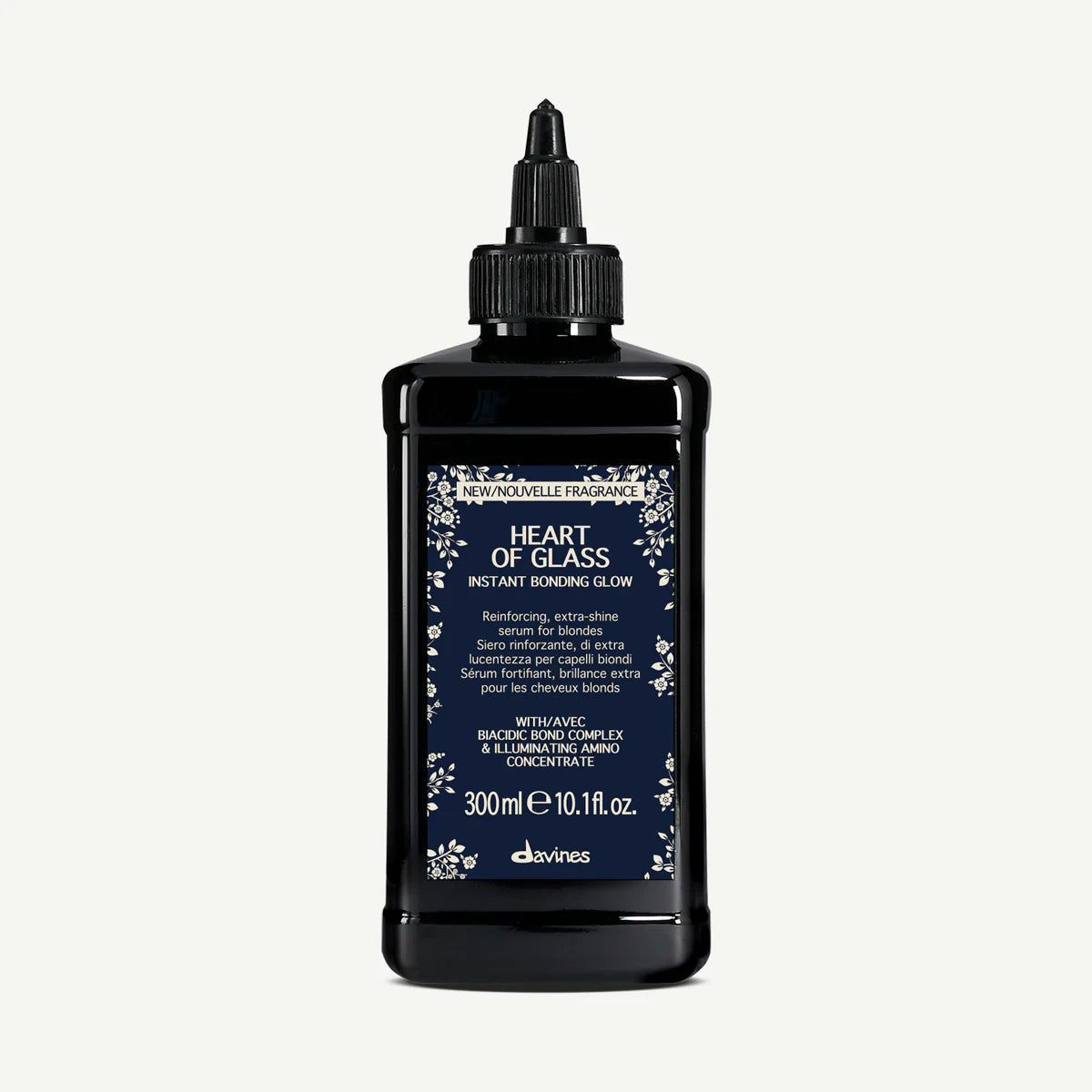 Heart of Glass Instant Bonding Glow i svart flaska med appliceringspip, en stärkande och glansgivande hårinpackning för blonda hår, miljövänlig hårvårdsprodukt.