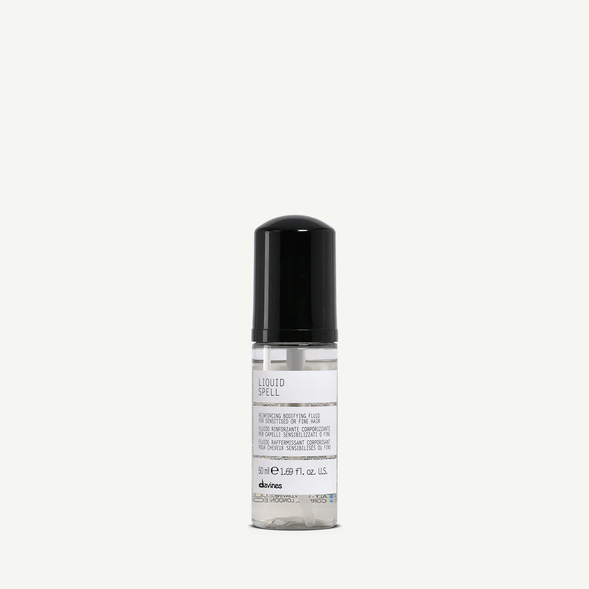 Flaska med Liquid Spell hårstylingprodukt från Davines, en klar vätska i en liten behållare med svart lock, perfekt för miljövänlig hårvård och styling.