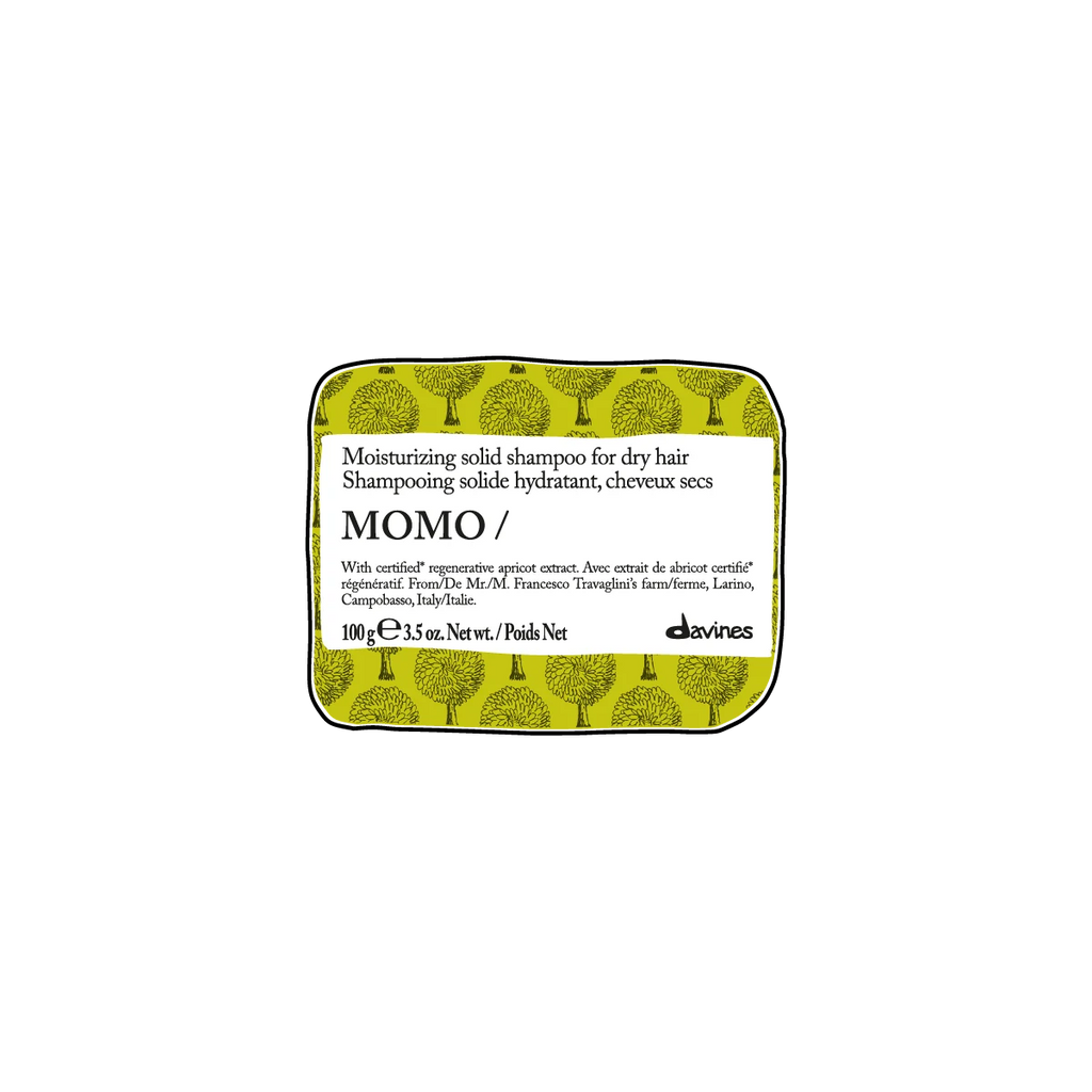 Momo Moisturizing Solid Shampoo Bar i fast form med fuktgivande egenskaper för torrt hår, förpackad i en grön ask med stilfullt trädmönster.