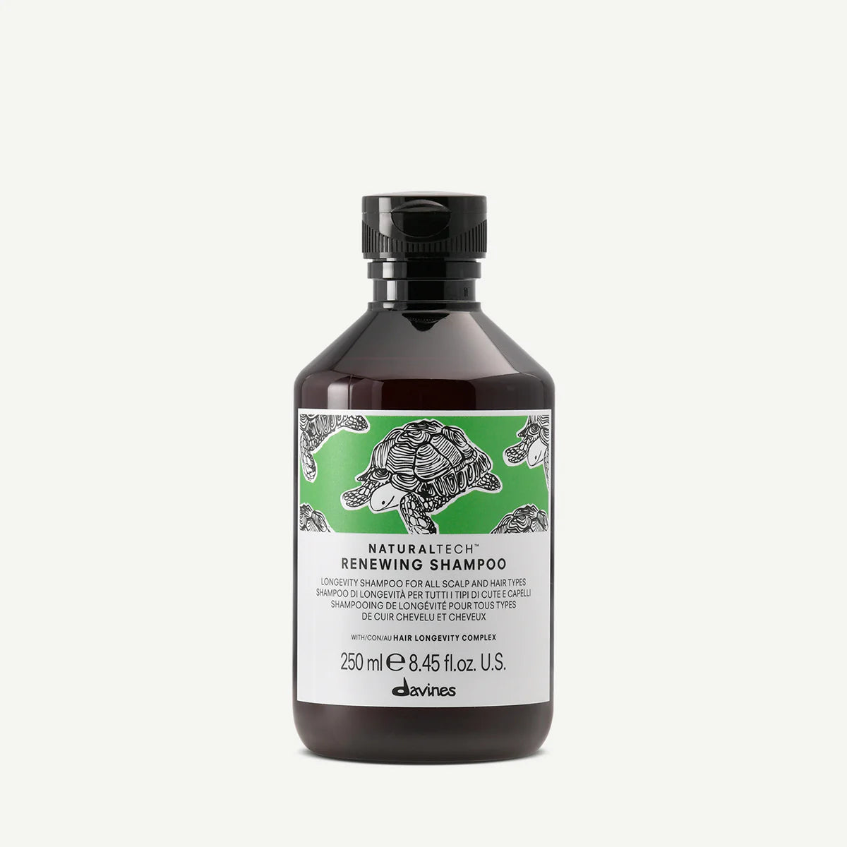 Flaska med Naturaltech Renewing Shampoo, ett miljövänligt schampo med fokus på hårbotten och långt hår, med illustrationer av sköldpaddor på etiketten.