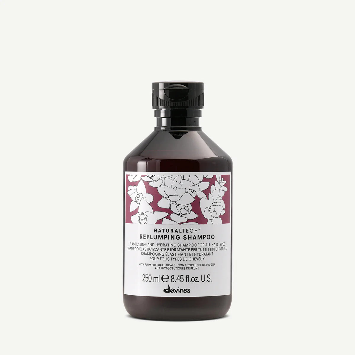 Naturaltech Replumping Shampoo i mörk flaska med etikett i vitt och vinrött, miljövänligt schampo som ger fyllighet och återfuktning till håret.