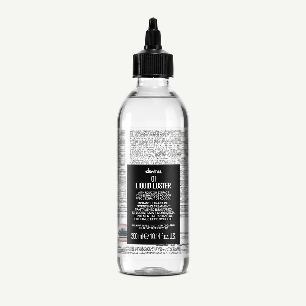 Transparent flaska med svart kork och appliceringspip för OI/Liquid Luster, ett styling- och vårdande hårprodukt med återfuktande egenskaper.