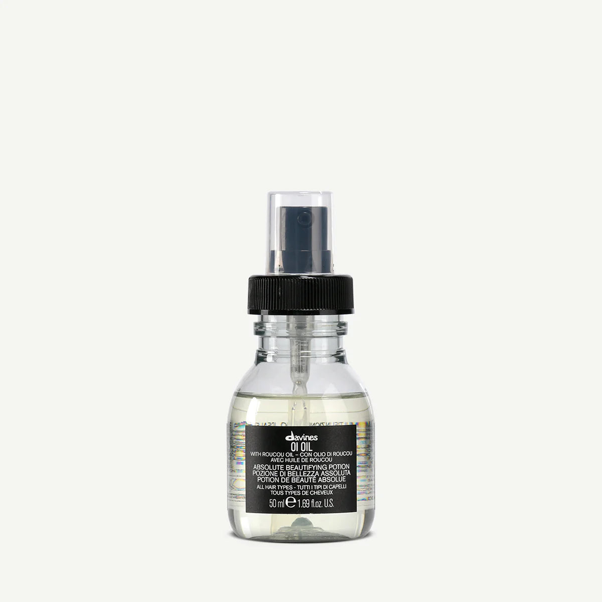 Flaska med transparent OI/Oil hårvårdsprodukt från Davines, en lätt stylingolja för vård och glans av håret i en miljövänlig förpackning.