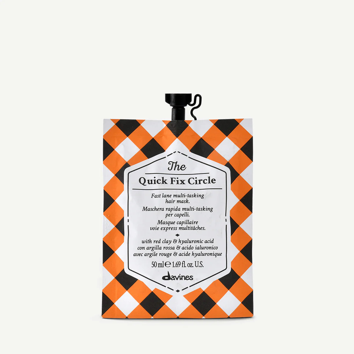 The Quick Fix Circle hårinpackning i liten förpackning med orange, svart och vit rutig design, miljövänlig och reparerande stylingprodukt.