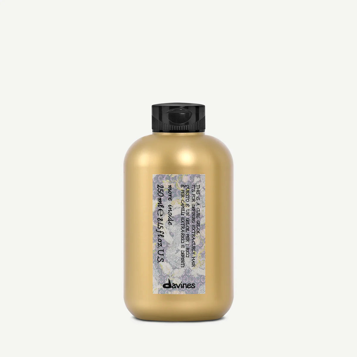 Flaska med This is a Curl Gel Oil i guldig förpackning och svart lock, en stylingprodukt för att definiera och vårda lockigt hår.