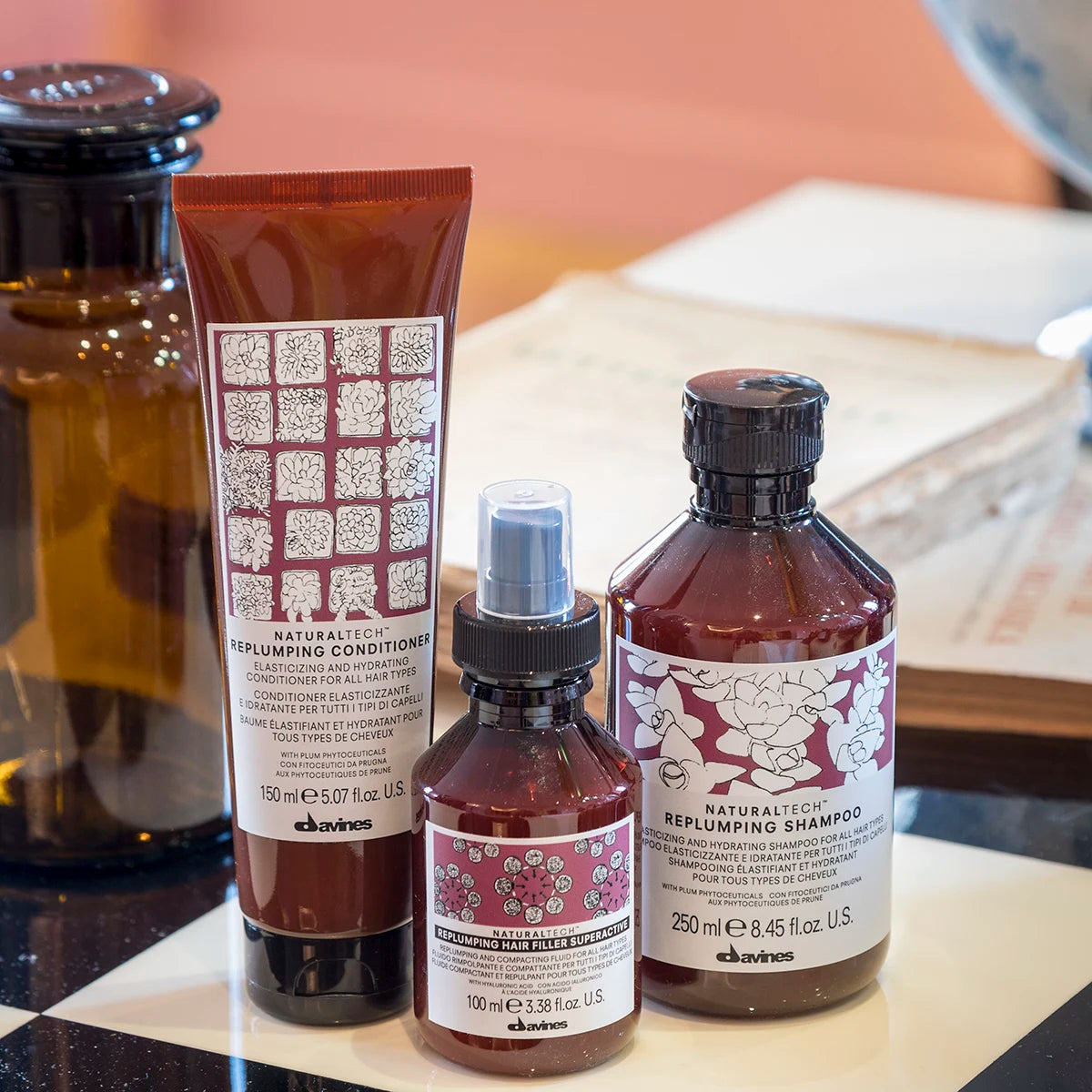 Naturliga hårvårdsprodukter från Davines med Naturaltech Replumping Hair Filler, inklusive schampo, balsam och hårinpackning i elegant design för fylligare och friskare hår.